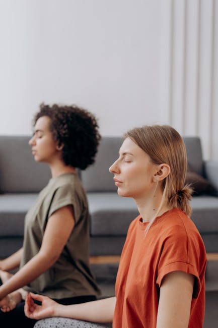 Woman practicing a gentle yoga pose in a beautifully lit, calm room.